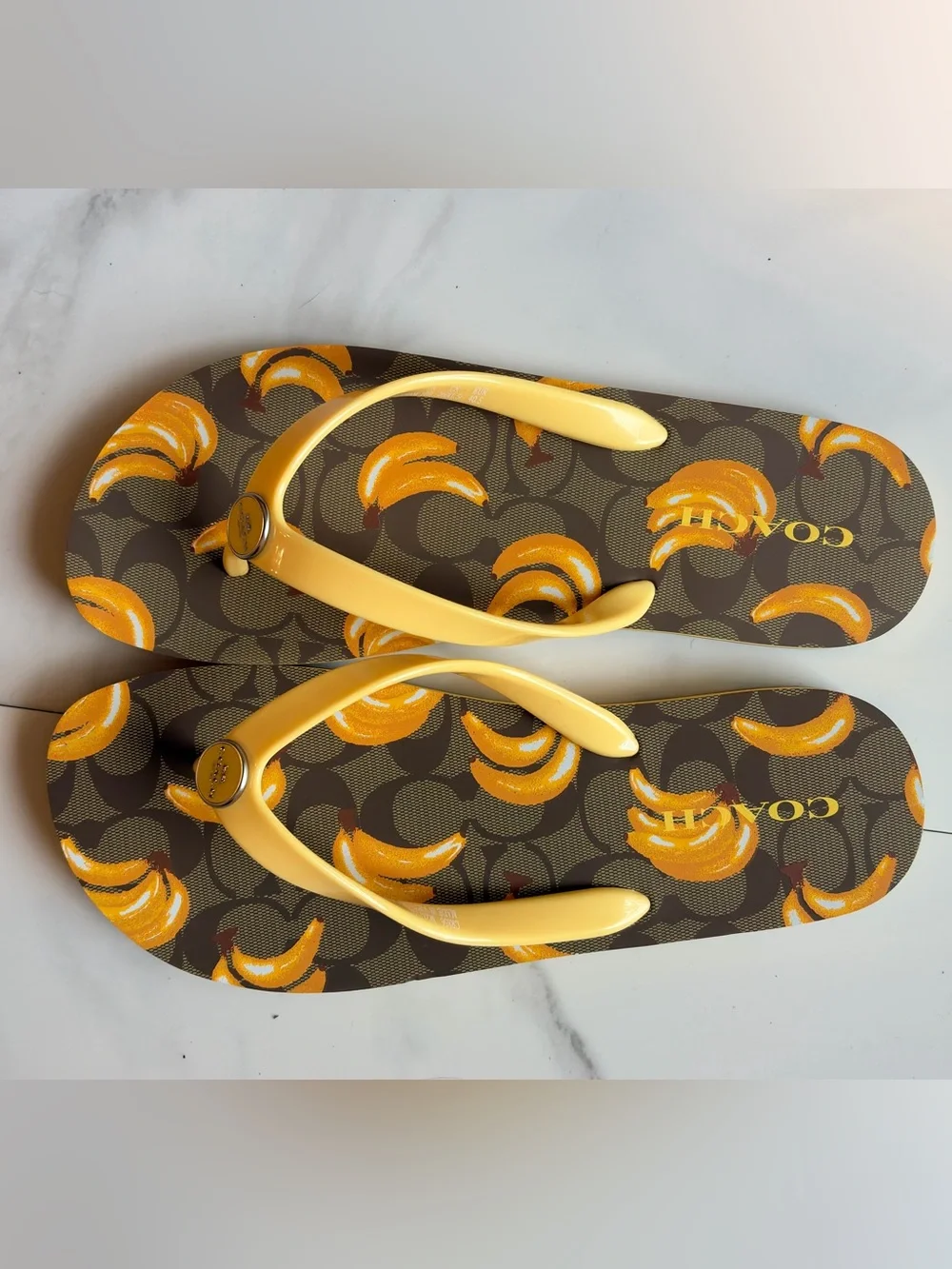 COACH banana print flip flops